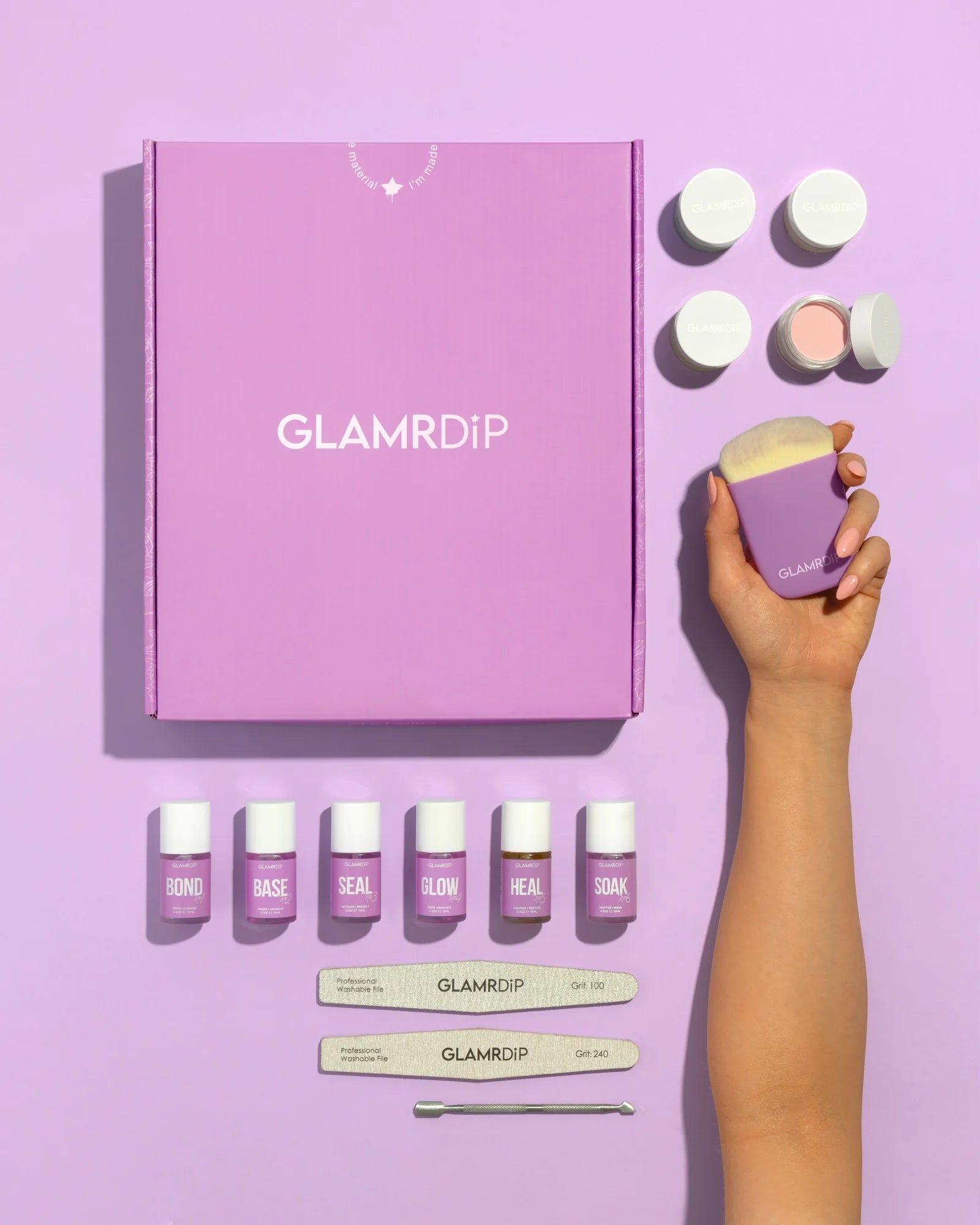 GLAMRDiP Salon Kit flatlay — purple gift box, 6 liquid bottles, dip pots, files, brush, and cuticle pusher